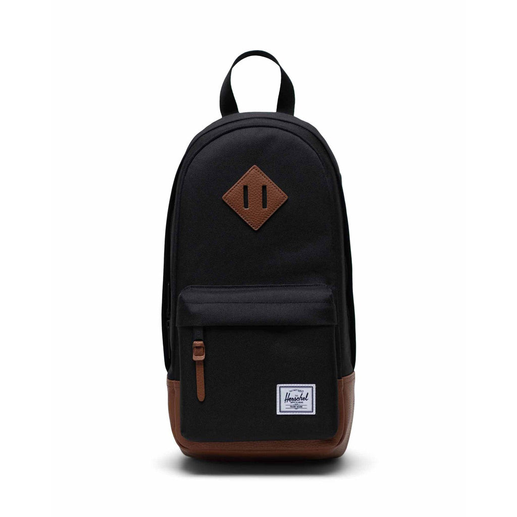 Herschel Heritage Shoulder Bag - Black/Tan - 8L - 35cm (H) x 19cm (W) x 12cm (D) EcoSystem™ 600D Fabric made from 100% recycled post-consumer water bottles. Shop Herschel premium backpacks and wallets online with Pavement and enjoy free NZ shipping over $150. 