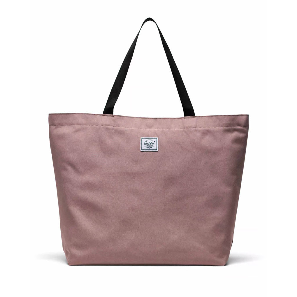 Herschel Classic Tote - Ash Rose. 24L 36cm (H) x 49cm (W) x 14cm (D). EcoSystem™ 600D Fabric made from 100% recycled post-consumer water bottles. Tonal stripe EcoSystem™ Liner made from 100% recycled post-consumer water bottles. Metal snap closure. Smooth webbing top-carrying handles Internal storage sleeve. 