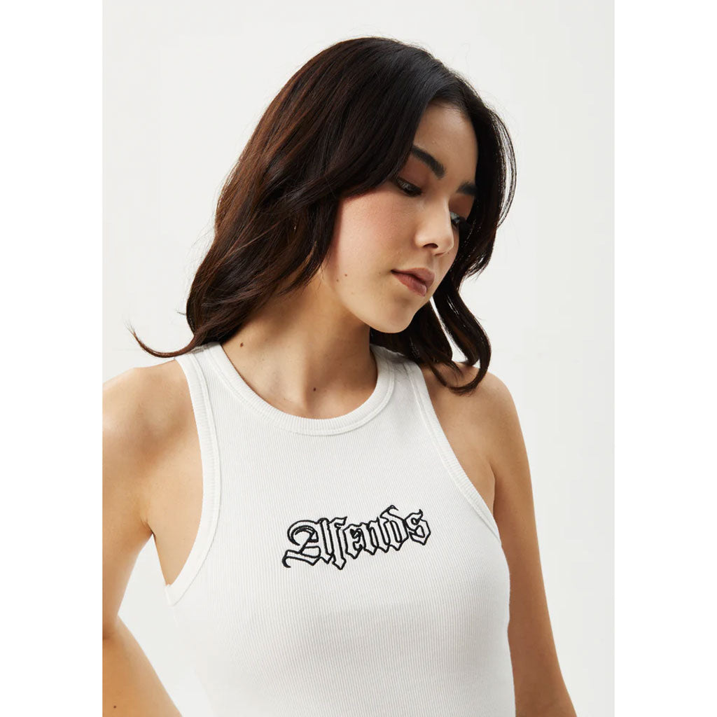 Afends Burning Organic Rib Singlet - White. Womens High Neck Tank. Ribbed 50% Organic Cotton 47% Recycled Cotton 3% Spandex, 360gsm. Shop Afends women's clothing online with Pavement. Free, fast NZ shipping over $150. Same day delivery Dunedin before 3. Easy, no fuss returns. Pavement skate stereo, Ōtepoti.
