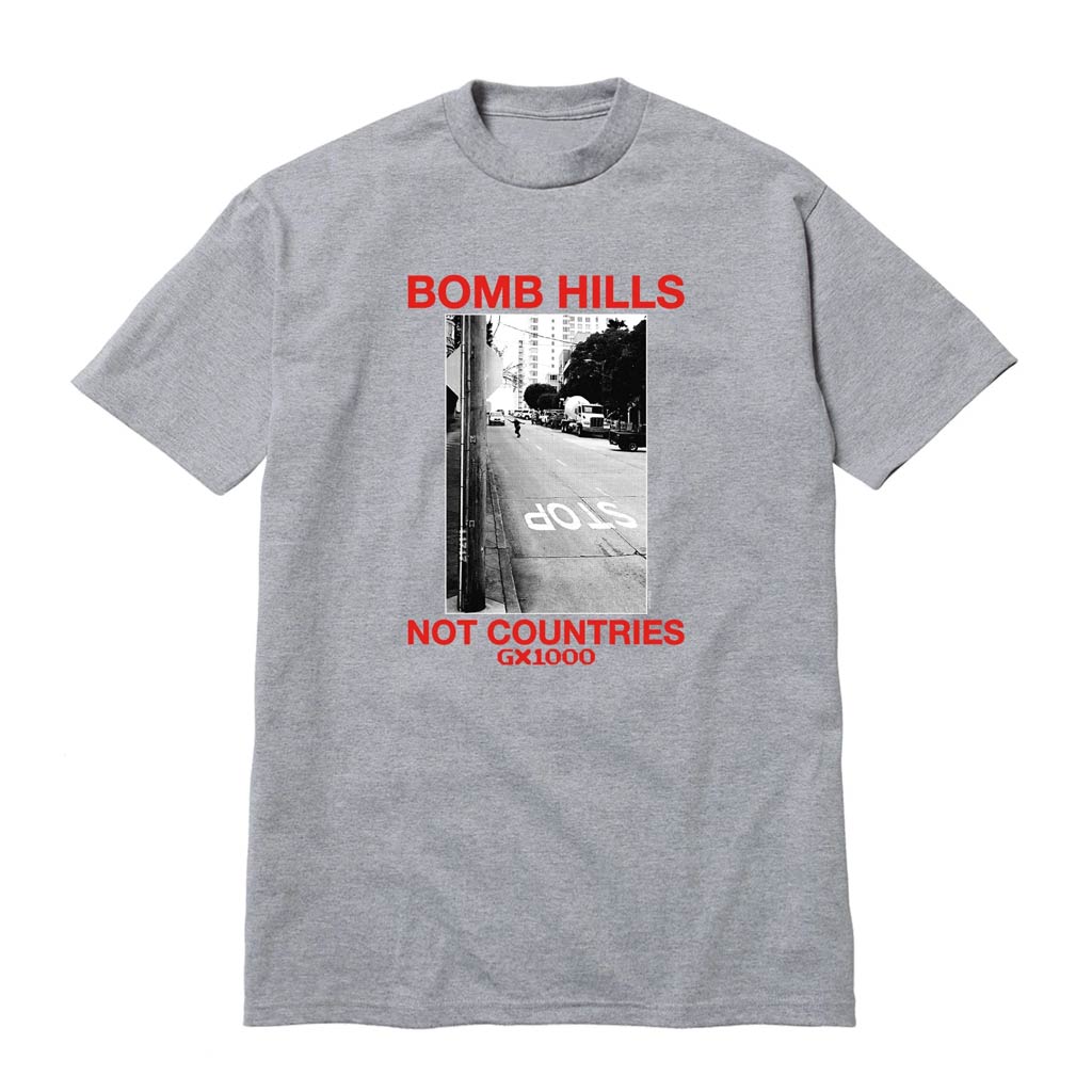 GX1000 Bomb Hills Not Countries - Heather Grey/Red Text. Regular fit. Short sleeves. Mid weight cotton. Ribbed crewneck. Printed graphics at front. 100% Cotton. Shop GX1000 skateboard decks and clothing with Pavement online. Free, NZ shipping over $150.