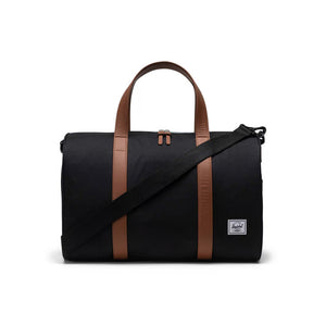 Herschel Novel Carry One Duffle - Black. Re-invented bestselling  Herschel duffle for carry-on travel. Built with a padded laptop sleeve and trolley strap, it attaches to your luggage for your next trip. 27L 28cm (H) x 43cm (W) x 25cm (D). Comes with Herschel Lifetime Warranty. Shop Herschel online with Pavement.