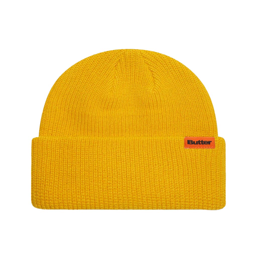 Butter Goods Tall Wharfie Beanie - Yellow. Loose knit acrylic fold beanie. Tall wharfie fit. Woven label on front. Size: OSFA. Shop Butter Goods online with Pavement skate store and enjoy free Aotearoa shipping over $150, same day Ōtepoti delivery and easy returns.
