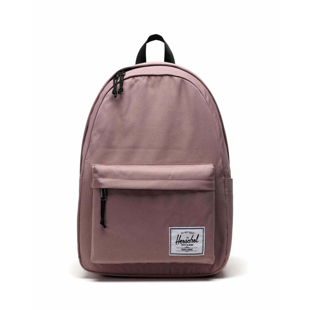 Herschel Classic Backpack XL - Ash Rose. 26L - 45cm (H) x 32cm (W) x 17cm (D) EcoSystem™ 600D Fabric made from 100% recycled post-consumer water bottles. Shop Herschel premium bags, backpacks and wallets with Pavement online. Free, fast NZ shipping over $150.