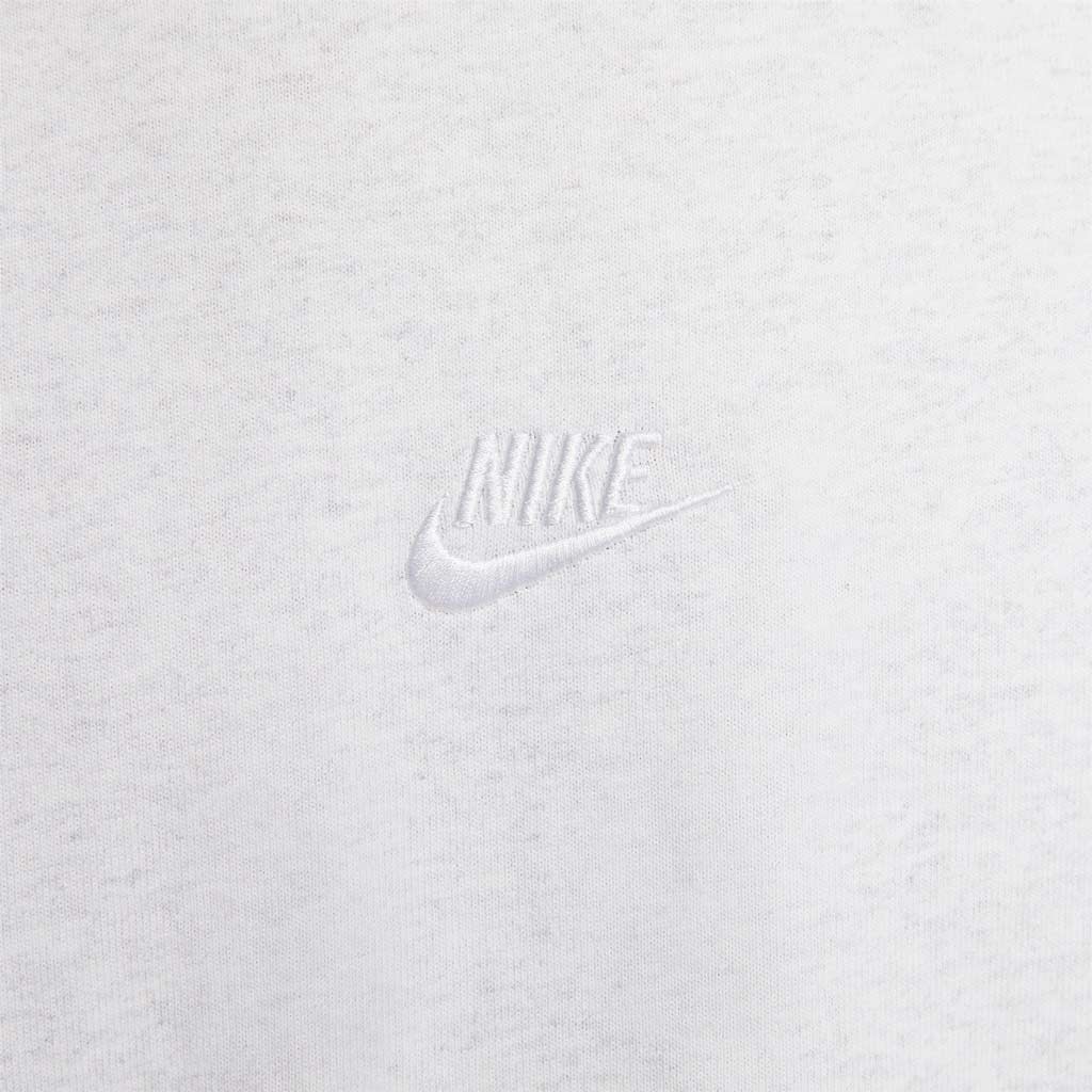 Nike Sportswear Premium Essentials Tee - Birch Heather. Loose-fitting design features dropped shoulders and room through the chest and shoulders for a relaxed look and feel. Heavyweight cotton jersey has a stiff drape and dry hand for a crisp, thick feel. DO7392-051