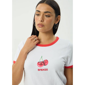Woman wearing a white t-shirt with red trim and cherry design, featuring the brand 'Cherries'.