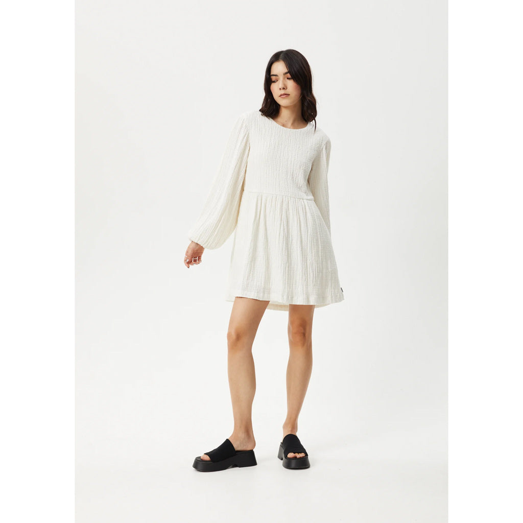 Afends Focus Seersucker Mini Dress - White. The perfect mini dress for when you want to slip into something easy. Crafted from an eco-friendly hemp seersucker, this dress offers a lightweight, breathable, and textured hand feel. Shop Afends women's clothing online with Pavement. Free NZ shipping over $150.