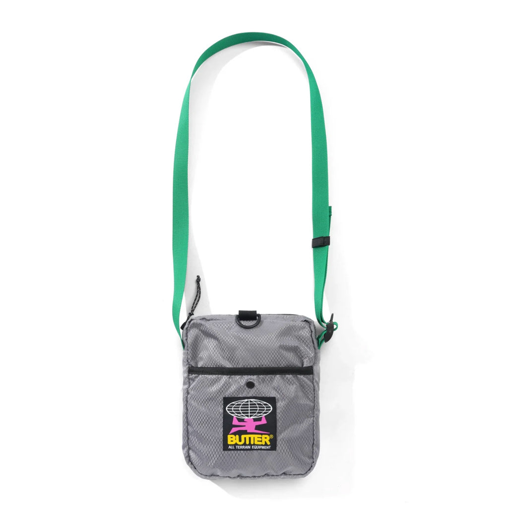 Butter Goods Ripstop Side Bag - Grey. 100% Ripstop nylon side bag. Top zip opening. Front snap pocket. Adjustable woven taping strap. Shop Butter Goods online with Pavement, Dunedin's independent skate store. Free NZ shipping over $150 - Same day Dunedin delivery, and easy returns.