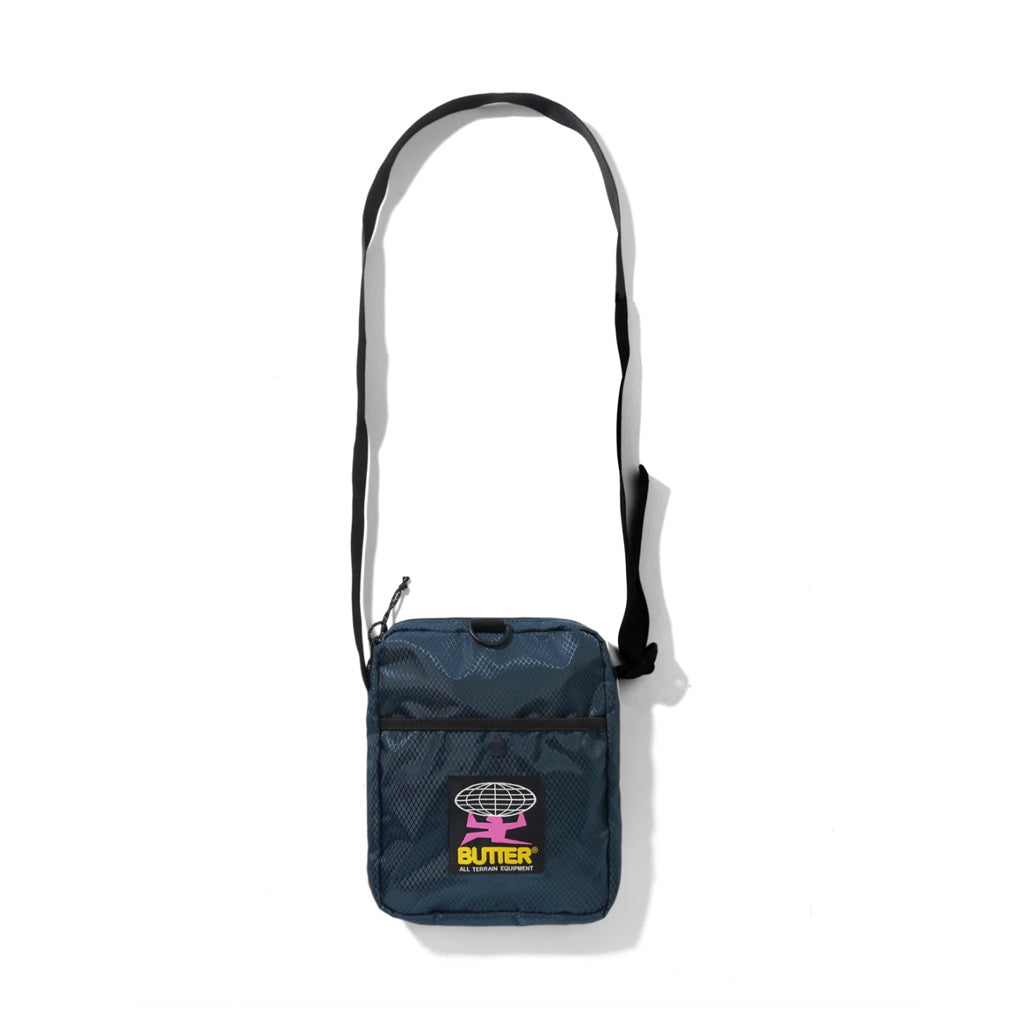 Butter Goods Ripstop Side Bag - Navy. 100% Ripstop nylon side bag. Top zip opening. Front snap pocket. Adjustable woven taping strap. Width 22.5cm / 8.8". Length 18cm / 7". Shop Butter Goods online with Pavement skate store. Free NZ shipping over $150. Easy returns.