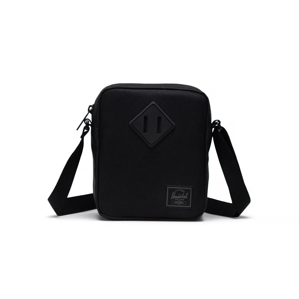 Herschel Heritage Crossbody - Black Tonal. 18cm (H) x 15cm (W) x 6cm (D) - 3L.  EcoSystem™ 600D Fabric made from 100% recycled post-consumer water bottles. Herschel Lifetime Warranty. Shop Hershel with Pavement online. Free, fast NZ shipping. Same day delivery Dunedin before 3. Easy no fuss returns.