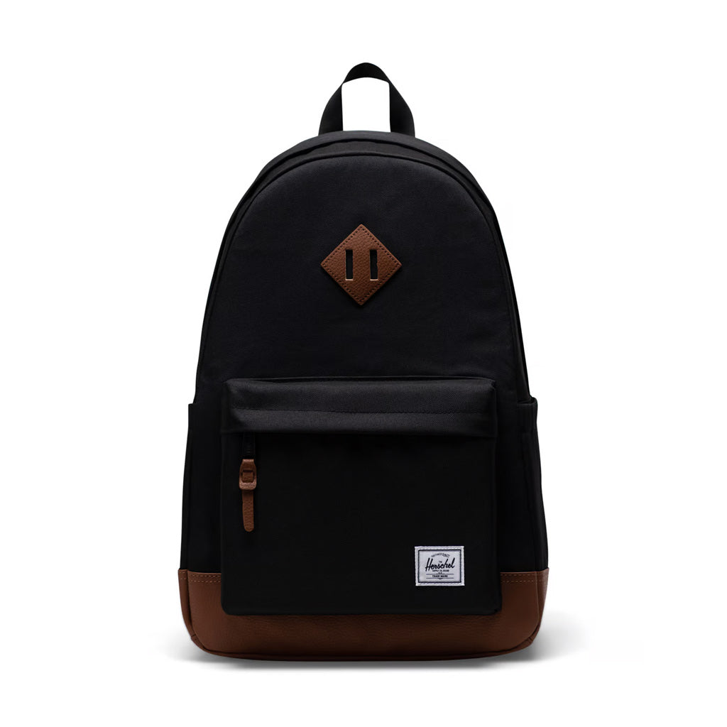 Herschel Heritage Backpack - Black/Tan. 24L 46cm (H) x 31cm (W) x 17cm (D). EcoSystem™ 600D Fabric made from 100% recycled post-consumer water bottles. Shop premium backpacks from Herschel, Carhartt WIP and Jansport online with Pavement and enjoy free NZ shipping over $150, and same day delivery Dunedin before 3*.