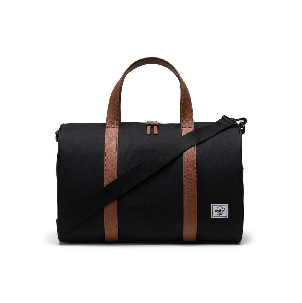 Herschel Novel Carry One Duffle - Black. Re-invented bestselling  Herschel duffle for carry-on travel. Built with a padded laptop sleeve and trolley strap, it attaches to your luggage for your next trip. 27L 28cm (H) x 43cm (W) x 25cm (D). Comes with Herschel Lifetime Warranty. Shop Herschel online with Pavement.