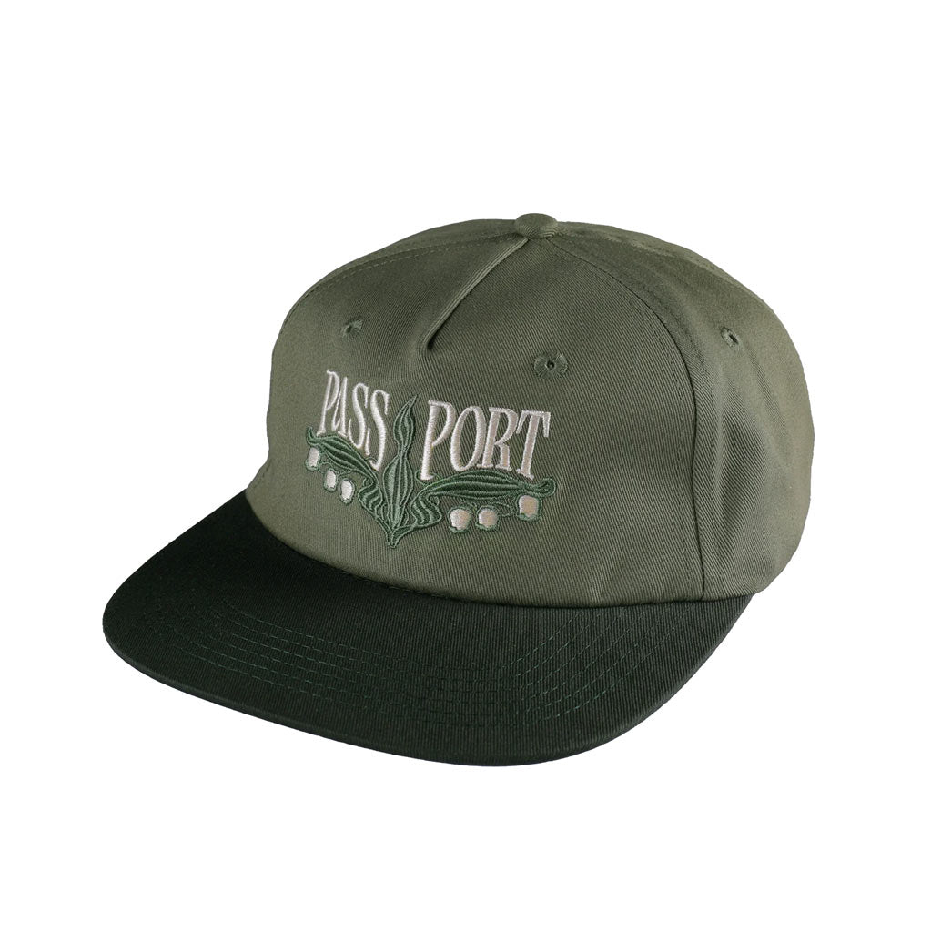 Pass~Port Lilly Of The Valley Workers Cap - Moss/Dark Military. Range #43. 5 panel construction made from 100% cotton twill and features direct embroidery with strap back adjustment. Shop Pass~Port skateboard decks, clothing and accessories online with Pavement Skate Shop NZ. Free shipping across Aotearoa over $100*.