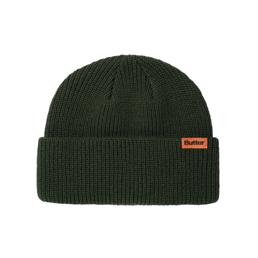 Butter Goods Tall Wharfie Beanie - Army. Loose knit acrylic fold beanie. Tall wharfie fit. Woven label on front. Size: OSFA. Shop Butter Goods online with Pavement skate store and enjoy free Aotearoa shipping over $150, same day Ōtepoti delivery and easy returns.