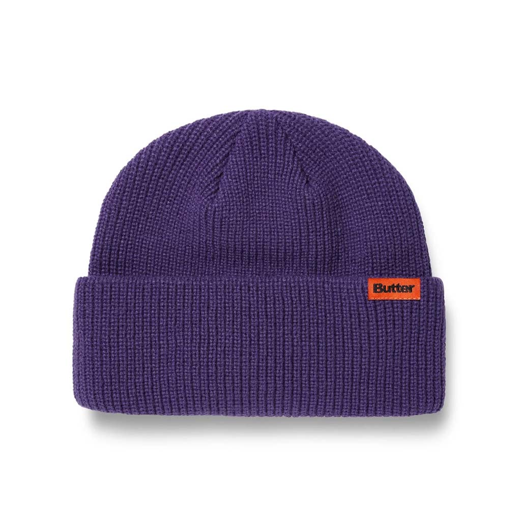 Butter Goods Tall Wharfie Beanie - Dusk. Loose knit acrylic fold beanie. Tall wharfie fit. Woven label on front. Size: OSFA. Shop Butter Goods online with Pavement skate store and enjoy free Aotearoa shipping over $150, same day Ōtepoti delivery and easy returns.