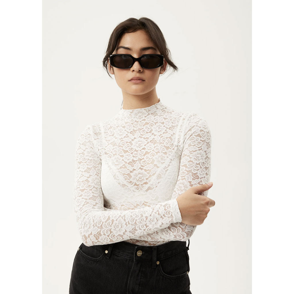 Afends Poet Lace Long Sleeve Top - White. Womens Lace Long Sleeve Top. Stretch Lace. Sheer. Tight fitted. True to size 90% Recycled Nylon, 10% Spandex Lace. Shop women's Afends clothing online with Pavement and enjoy free NZ shipping over $150, same day Dunedin delivery and easy returns.