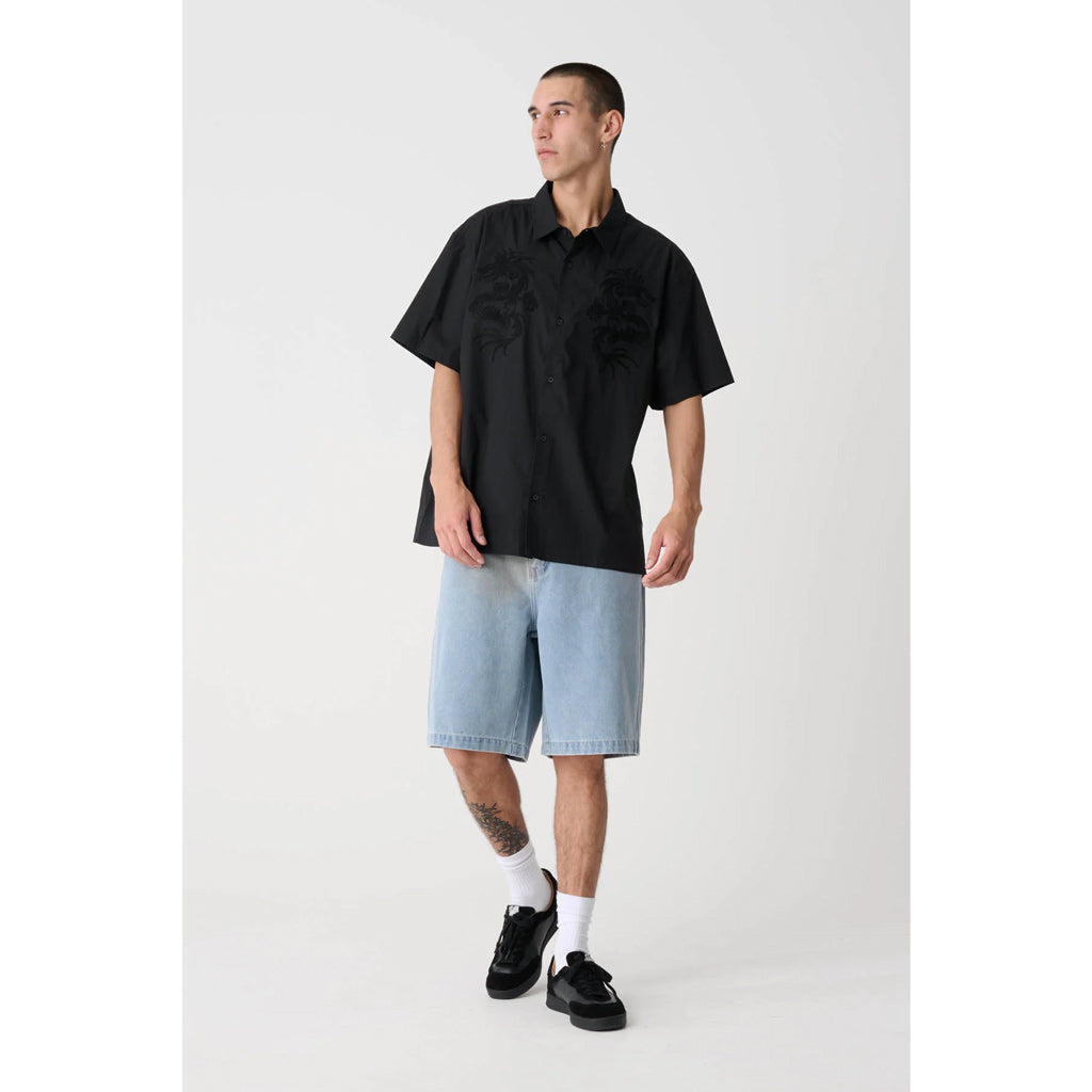 XLarge Dragon SS Shirt - Black. Oversized box-fit traditional short sleeve shirt. Chainstitch design on chest panels. Button up front. Soft washed finish. Branded buttons. Straight hem. 100% Cotton Poplin. Shop XLarge brand clothing online with Pavement and enjoy free shipping on your XLarge order over $150.