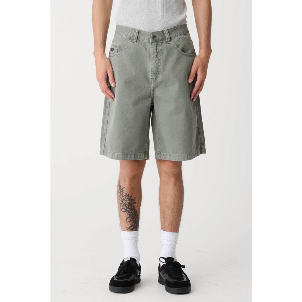 The XLarge Peace Man Bull Denim Short in Olive Grey is a fixed waist baggy fit. Features extra wide cut leg in a washed denim, they have an oversized waist with an extended rise, roomy thigh, and slightly tapered cuff. Shop XLarge clothing online with Pavement and enjoy free NZ shipping over $150.