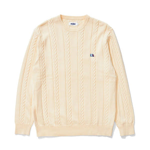 XLarge Cable Knit Sweater - Off White. Combed cotton sweater with cable knit detailing. Rib detailing on the cuffs, neckline, and hem band. Embroidered patch at the left chest. Made from 100% cotton. Free NZ shipping. Shop XLarge and X-Girl clothing. Pavement skate shop, Ōtepoti / Dunedin.
