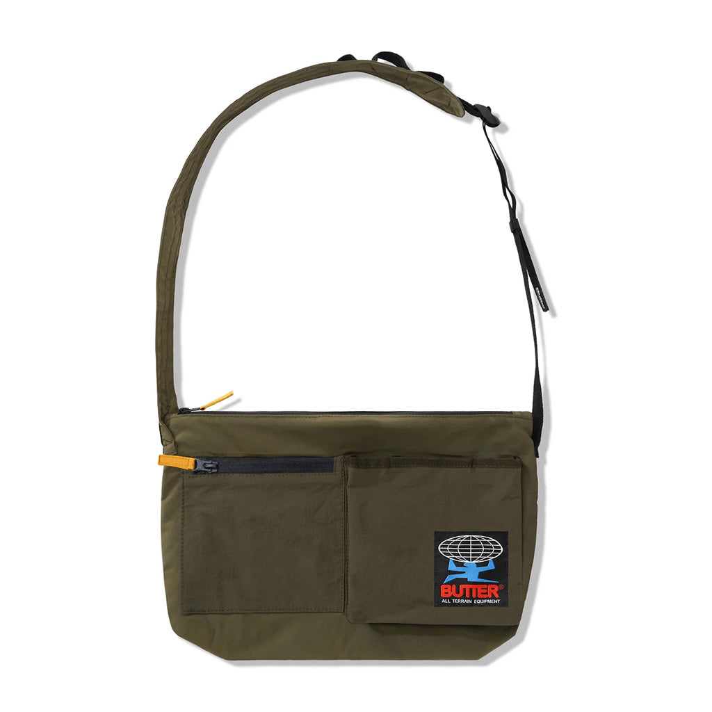 Butter Goods Terrain Sidebag - Army. 100% Nylon side bag. 3D Pocket with velcro closure. Utility strap on back. Woven label on front pocket. Adjustable woven taping strap. Shop premium Butter Goods clothing, headwear and accessories with Pavement online. Free, fast NZ shipping over $150. 