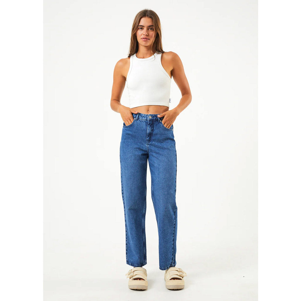 Afends Shelby Hemp Denim Wide Leg Jean - Authentic Blue. Womens Wide Leg Jean. High Waisted Fit. Wide Cut Leg. Ankle Length. Zip and Button Fastening. Belt Looped Waist. Four Pocket Styling. Signature Paper Patch On Waistband. Free NZ shipping with Pavement skate shop, Dunedin.